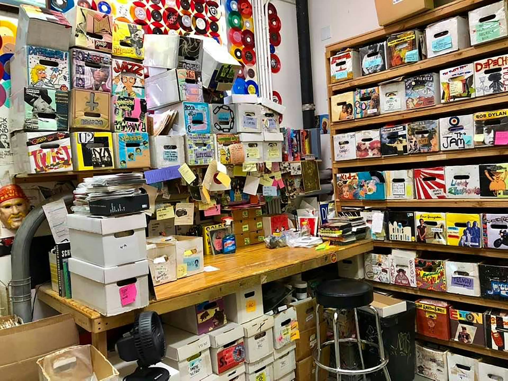 Amoeba L.A.’s 45 workstation, where listening, grading, and pricing take place. Boxes decorated by Tuna Tartugna.